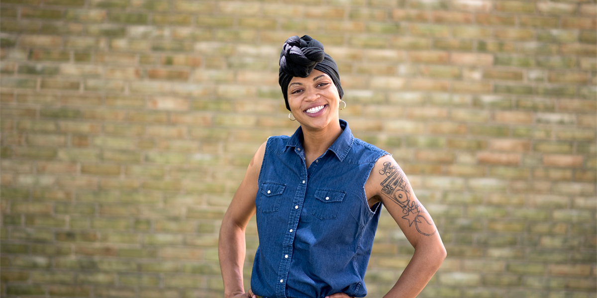 Nyia standing in front of brick building