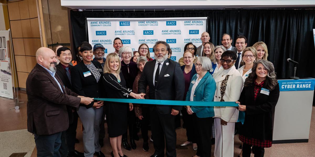 Group of people posed to cut a ribbon