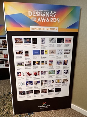 A sign showing various UCDA award submissions, including AACC's.