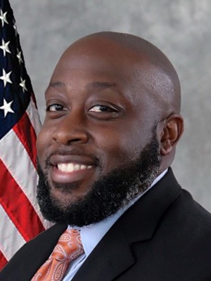 Daniel Ruffin portrait with the U.S. flag in the background.