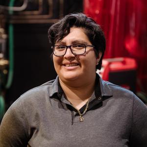 Angelica smiling in a welding lab.