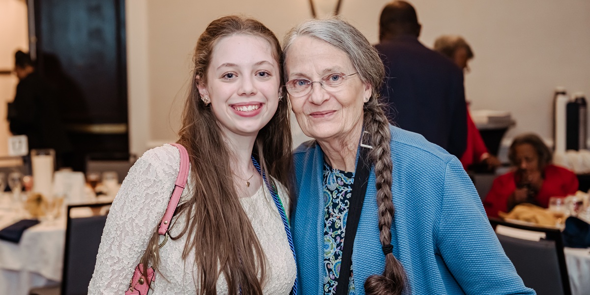 Brynn posing with an older woman at the Impact and Excellence Awards.