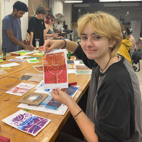 Student with their artwork.