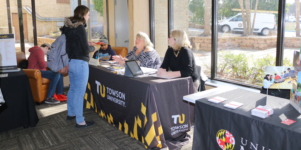 A student talking to representatives from Townson University.