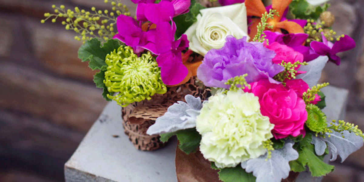 Bouquet of flowers in a vase sitting on a table.