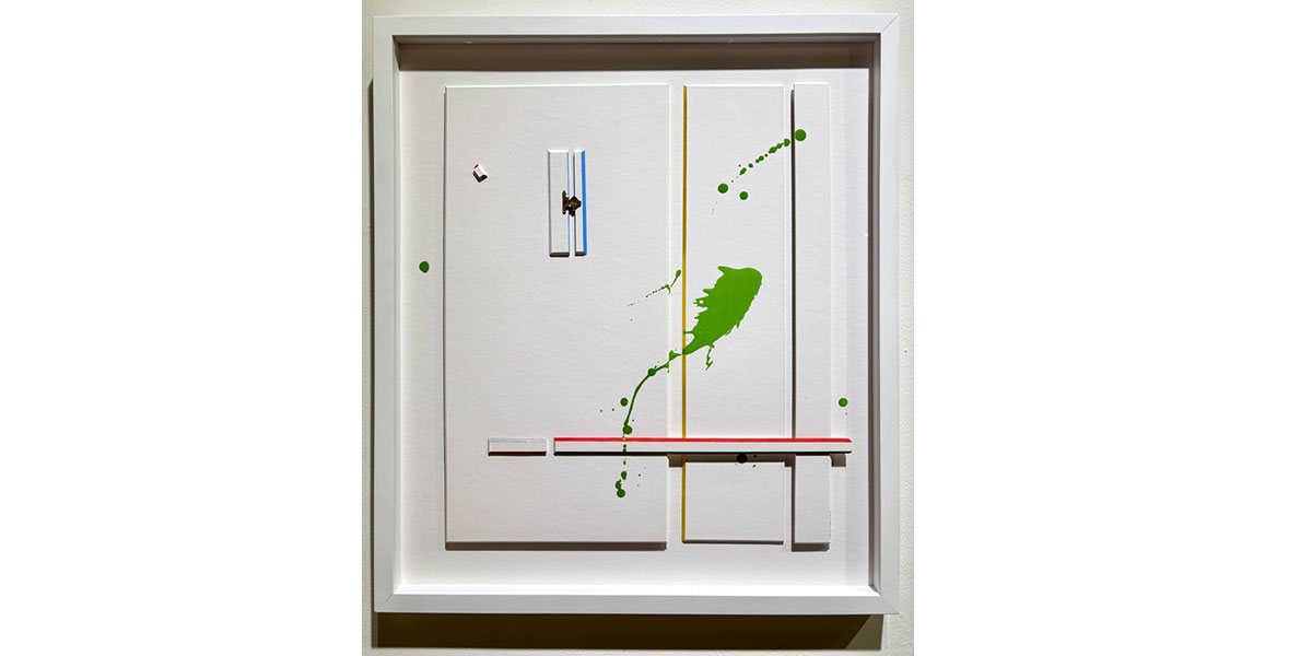 A framed abstract geometric relief artwork  featuring vertical yellow lines, a horizontal red stripe, and a prominent central green paint splash and scattered dots.