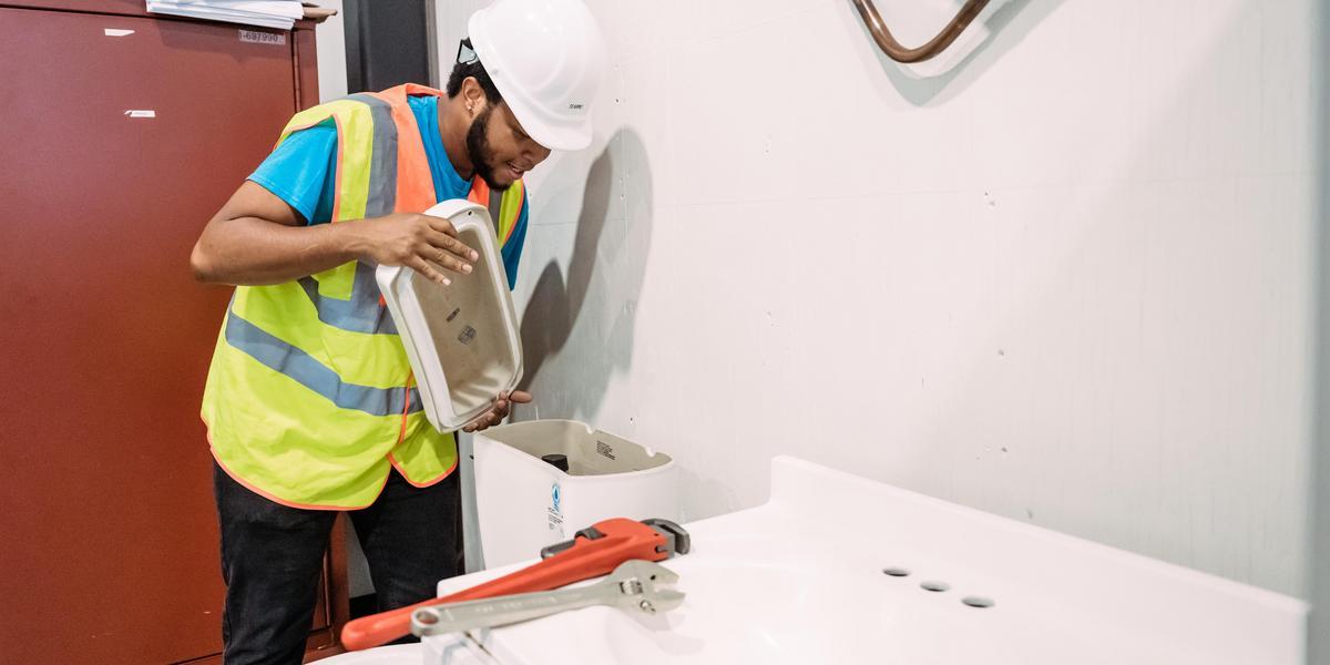 Student working on a toilet
