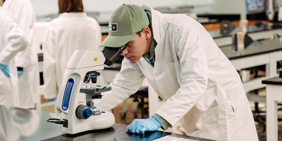 Student using lab equipment in histotechnician lab.