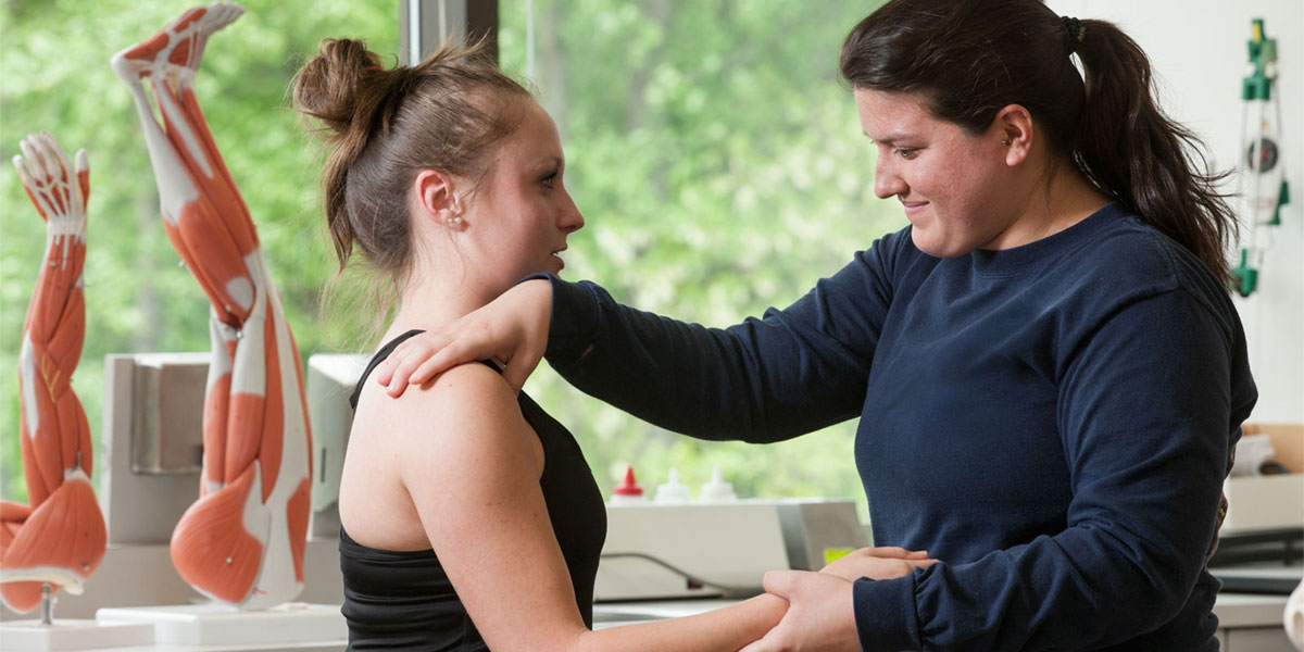 Physical therapist works with patient.