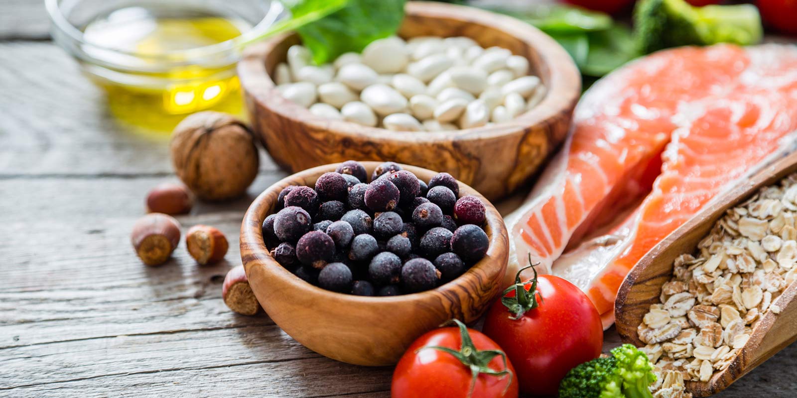 Display of healthy food including fish, blueberries and nuts.