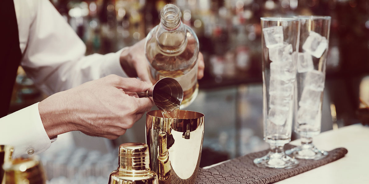 Bartender preparing a mixed drink.