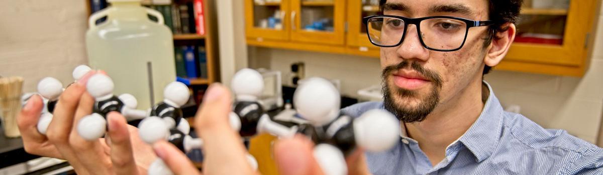 Student holding object in science class