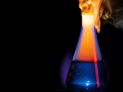 A beaker with liquid in it and steam coming out to the top