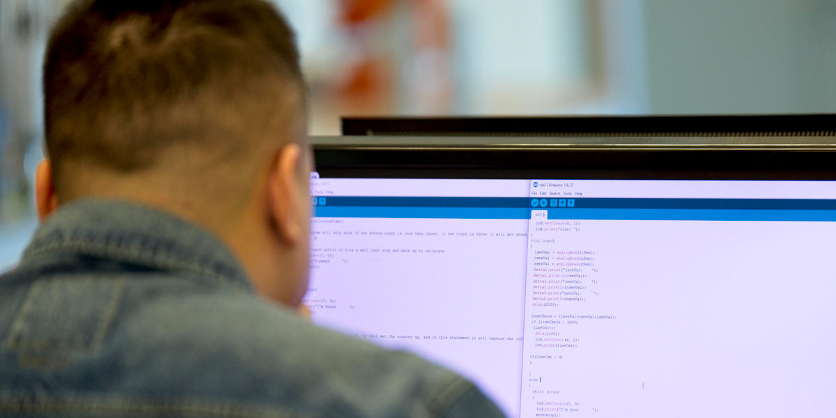 Student in technology course with code.