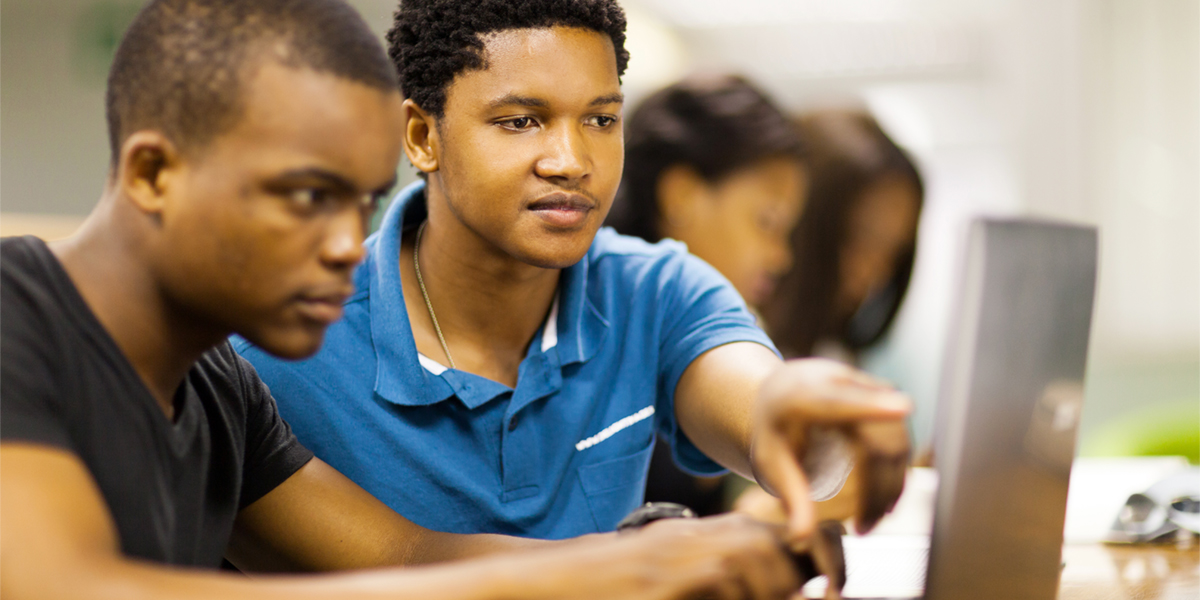 male students working at computer