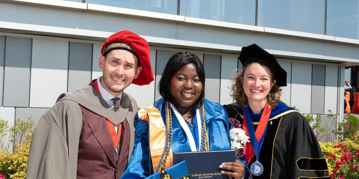 AACC professor Tim Mayhill with a student and AACC professor Candice Mayhill at commencement.