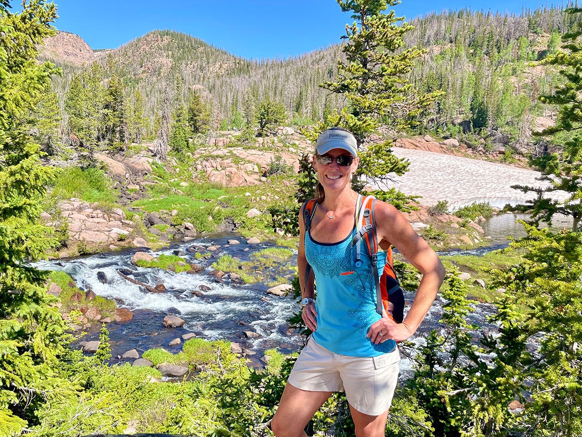 Cory Doubek standing in front of a lake and mountains