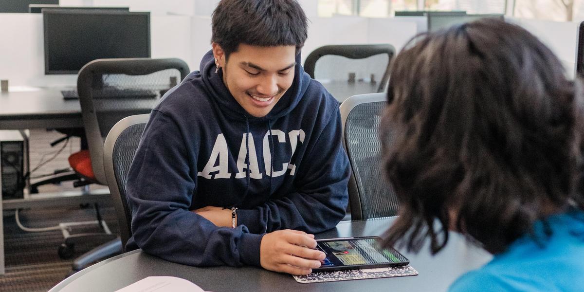 Two students talking to one another.