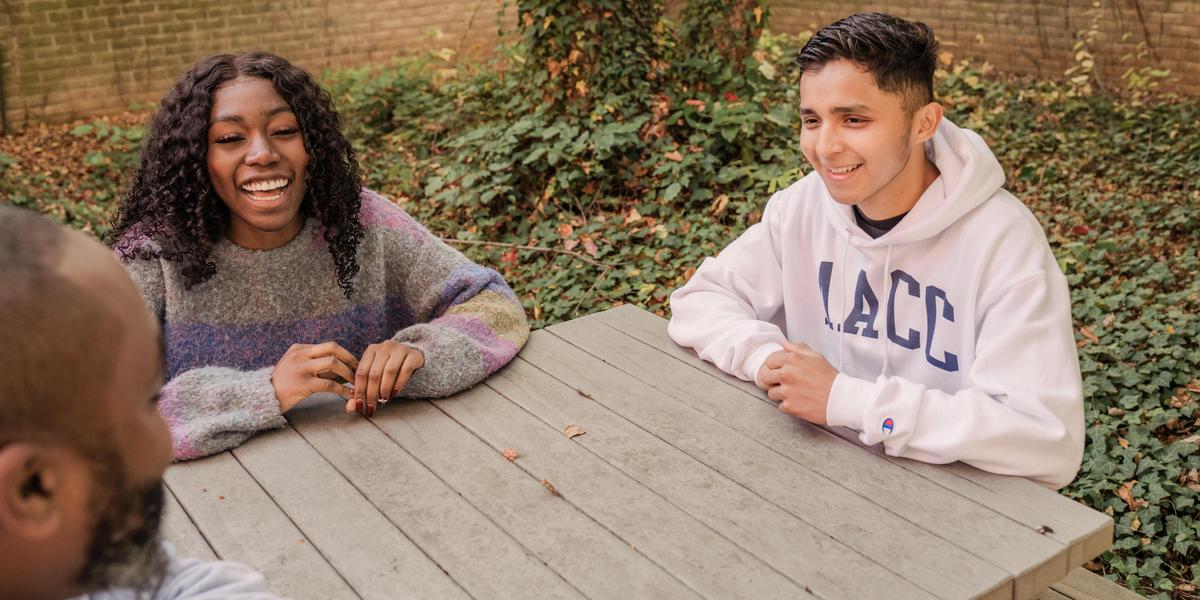 AACC students sitting at picnic table.